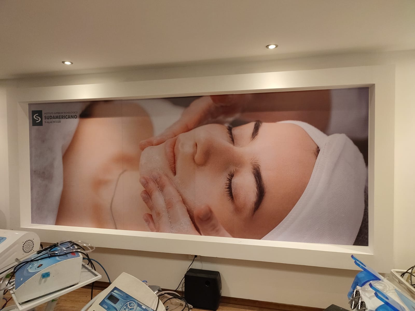 Fotomural de tratamiento facial enmarcado en la pared del Instituto Sudamericano