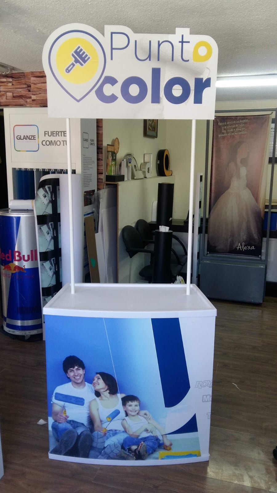 Counter promocional de Punto Color con foto de una familia pintando y letrero recortado arriba